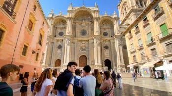 Students walking near old buildings in spain.